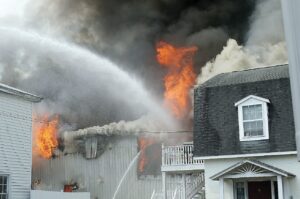 Firefighters battle flames in a Martin-Sale warehouse.
