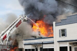 A ladder truck was utilized to combat flames that engulfed the Martin-Sale Furniture building.