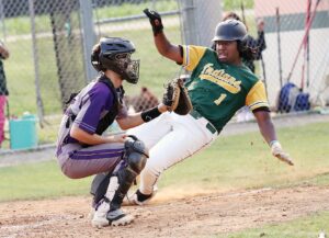 Northumberland’s Kenyon Ball starts to slide at home plate as Essex catcher Jacob Durham awaits a relay throw. Ball scored from second base on Cameron Minor’s two-out single in the second inning.