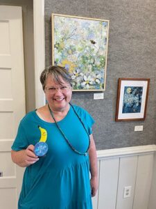 First Prize winner Carol Chandler with her piece, A New Tweet.