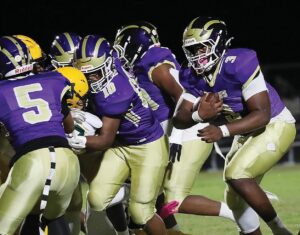Essex running back Demetrius Stewart gets blocks from teammates Travis Burrell (5) and Tim Walker on his way to some of his career-high 228 yards rushing.
