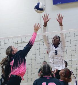 Lady Trojan Morgan Self attempts to block an attack by Colonial Beach’s Olivia Cooke.