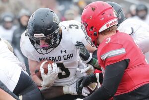 Buffalo Gap’s Isaac Goff runs into a pile of Rappahannock defenders as linebacker Chase Self prepares to make the tackle.